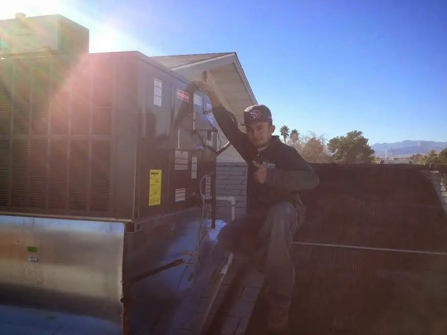 HVAC technician performing Boiler Repair on a rooftop unit in Winter Beach